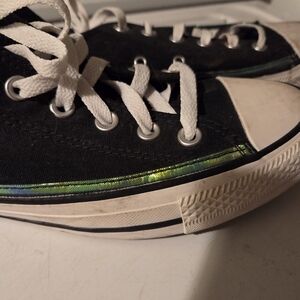 Classic black Converse sneakers with iridescent trim
